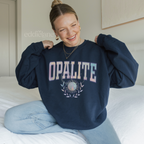 woman wearing a navy blue crewneck sweatshirt that says "opalite" in collegiate lettering