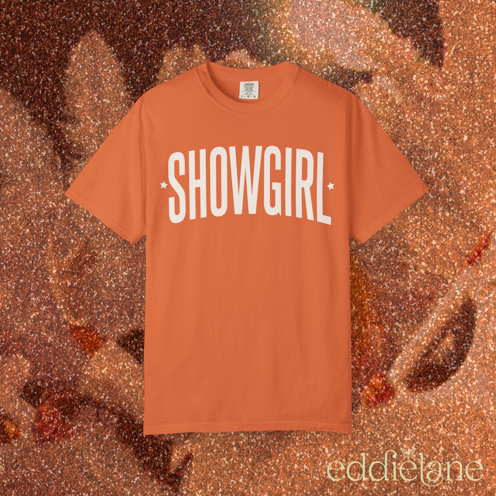 orange comfort colors graphic tee that says 'SHOWGIRL' with two small stars 

orange showgirl tee