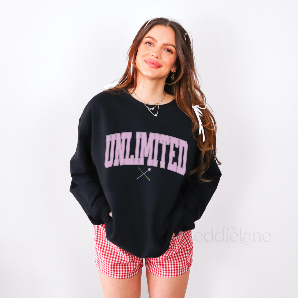 Woman wearing a black sweatshirt with 'UNLIMITED' text in a collegiate font, 