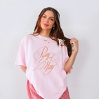 Woman wearing a pink oversized t-shirt with the words "pretty and witty" 
