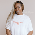 Woman wearing a white t-shirt with the words 'Pretty & Witty' and a lovely bouquet 