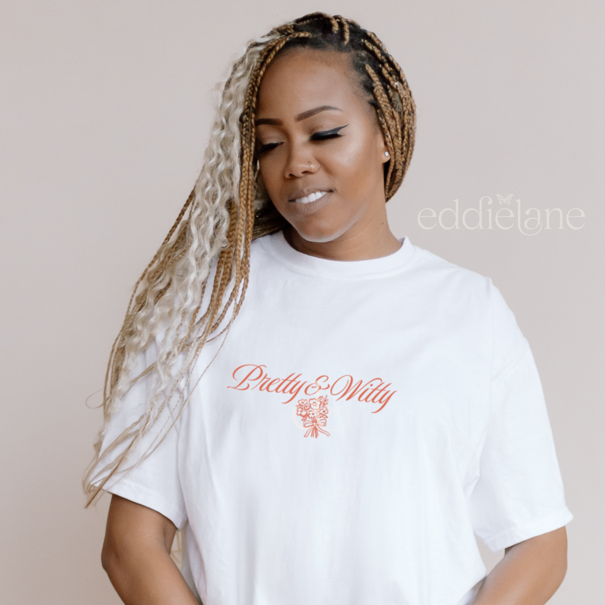 Woman wearing a white t-shirt with the words 'Pretty & Witty' and a lovely bouquet 