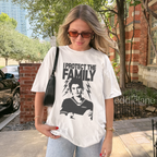 Woman wearing a white t-shirt with the words "I protect the family" and a graphic of a loving babysitter.