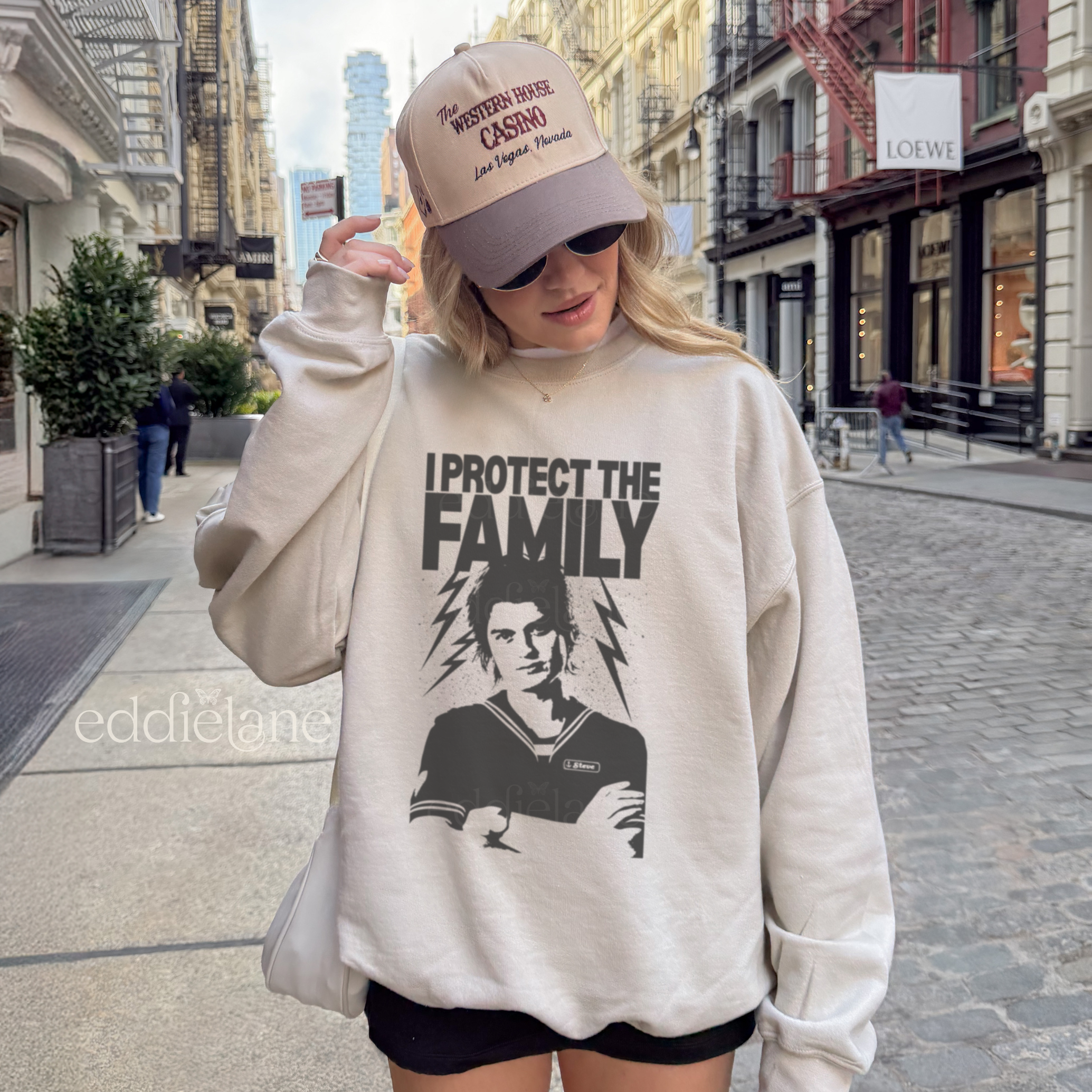 Woman wearing a sweatshirt with a graphic design and the words 