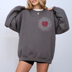 woman wearing a gray sweatshirt with a red heart design inspired by the fate of ophelia