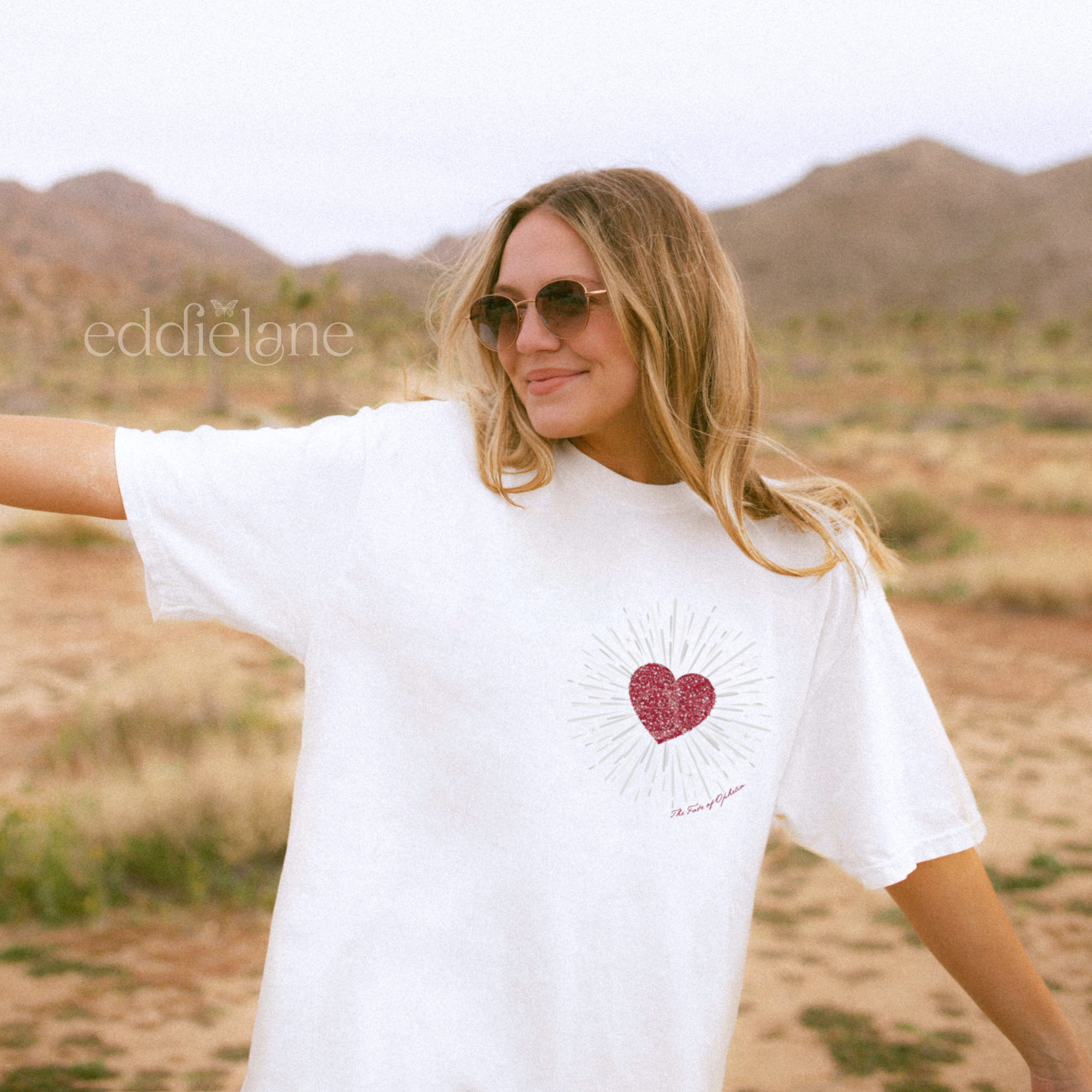woman wearing a white comfort colors tshirt with a red heart design inspired by the fate of ophelia