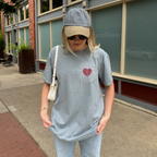 woman wearing a gray comfort colors tshirt with a red heart design inspired by the fate of ophelia