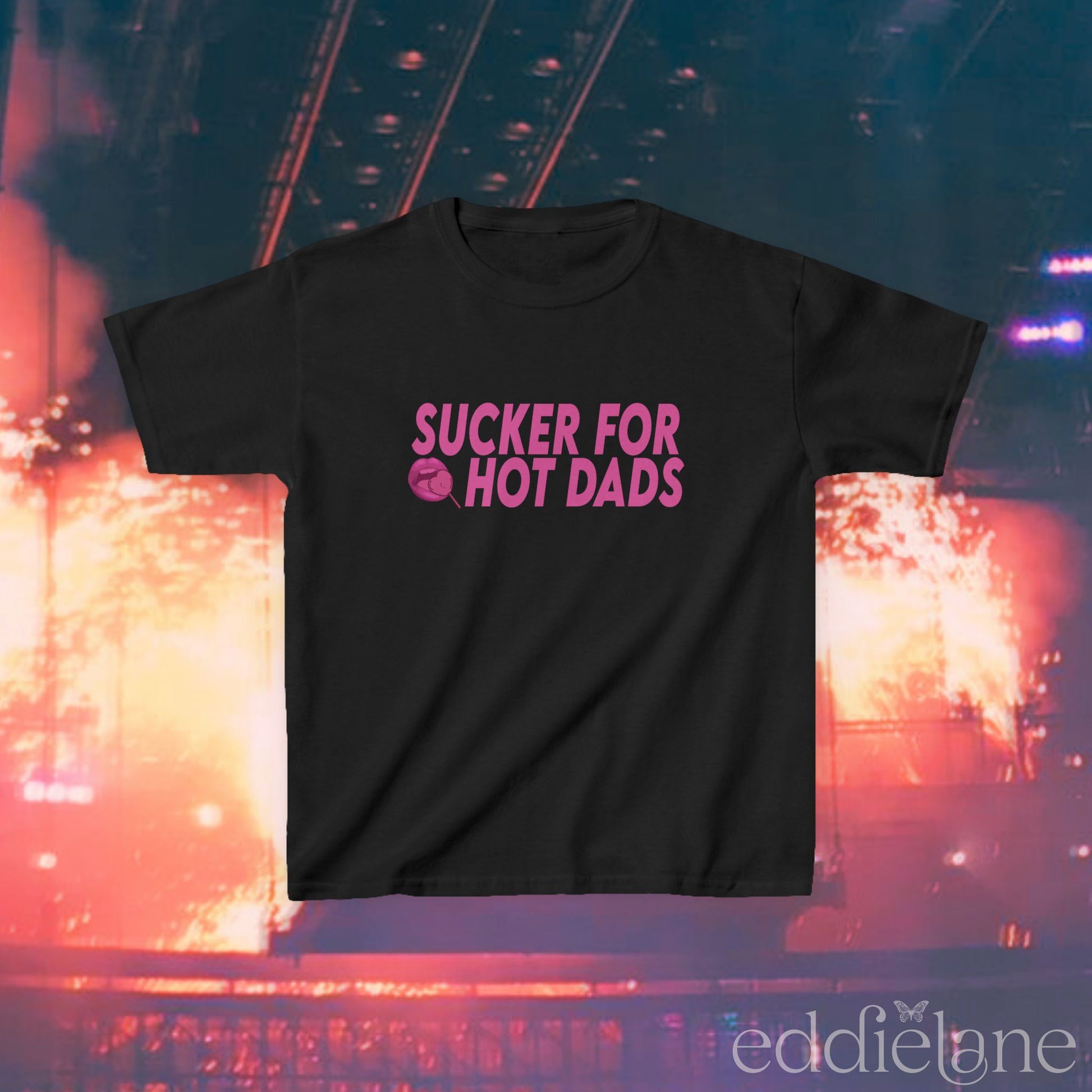 a black baby tee with dark pink design that says "sucker for hot dads" inspired by the jonas brothers.

sucker for hot dads black baby tee