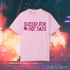A light pink comfort colors t-shirt that says "sucker for hot dads" 
