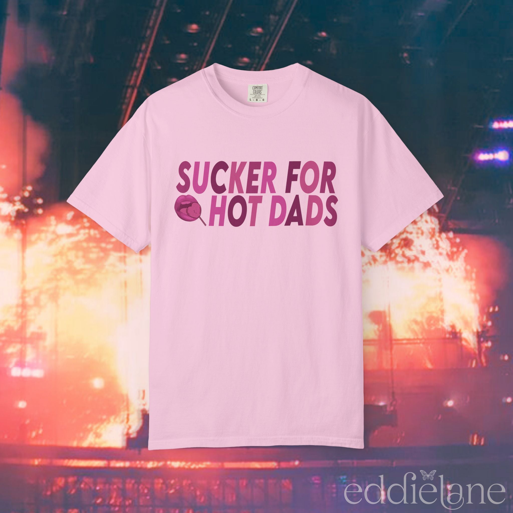A light pink comfort colors t-shirt that says "sucker for hot dads" 
