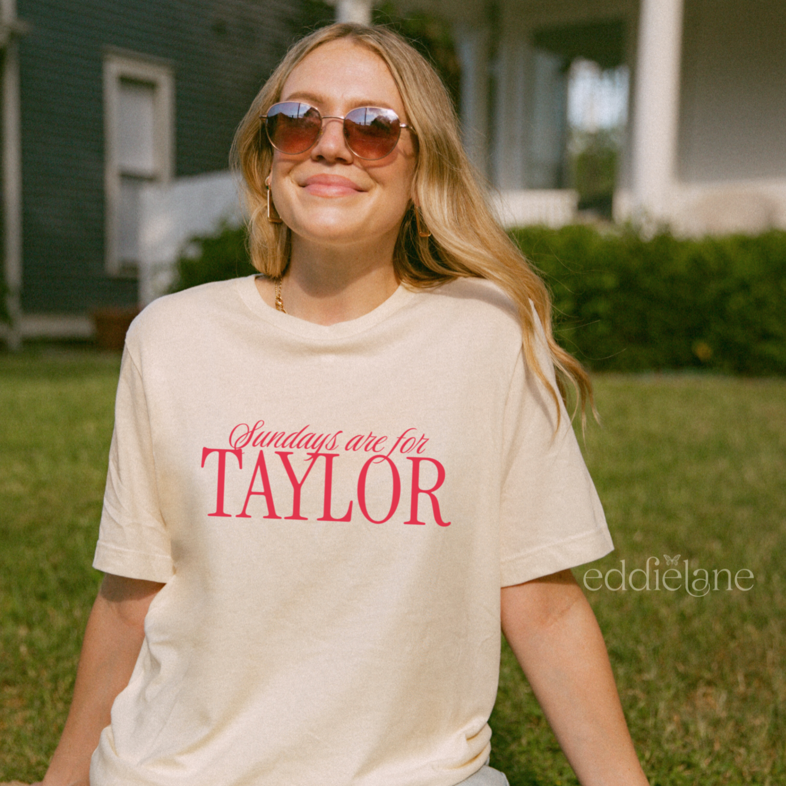 Woman wearing an ivory comfort colors t-shirt that says 'Sundays are for Taylor' 