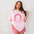 Woman in a pink oversized graphic tee that says "sweet mama it's the jonas brothers" 