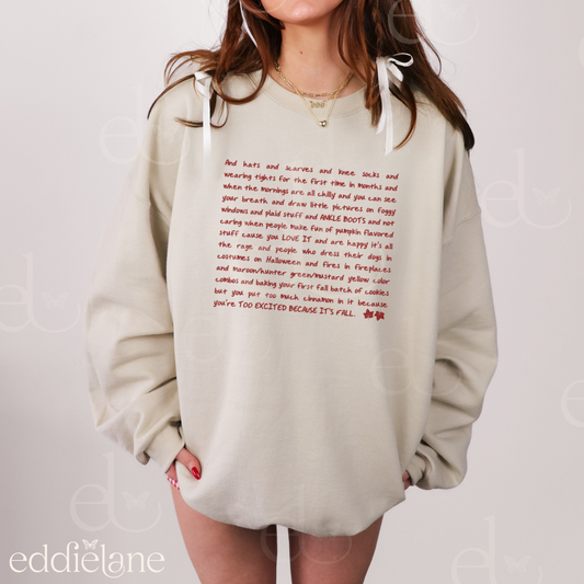 girl wearing an oversized crewneck sand-colored sweatshirt with a taylor swift quote about fall