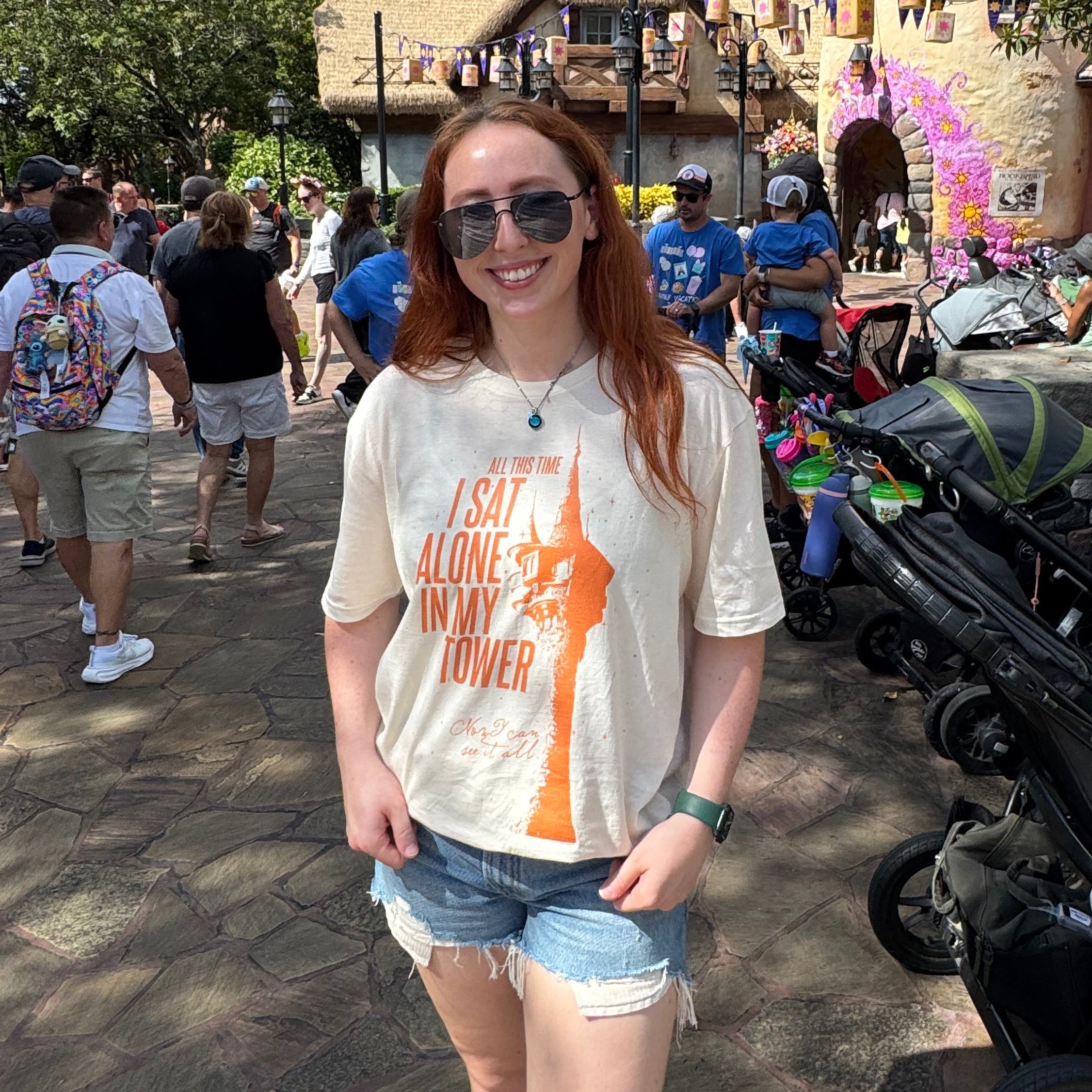 woman wearing an ivory comfort colors shirt with a graphic of a tower and the words "all this time i sat alone in my tower"