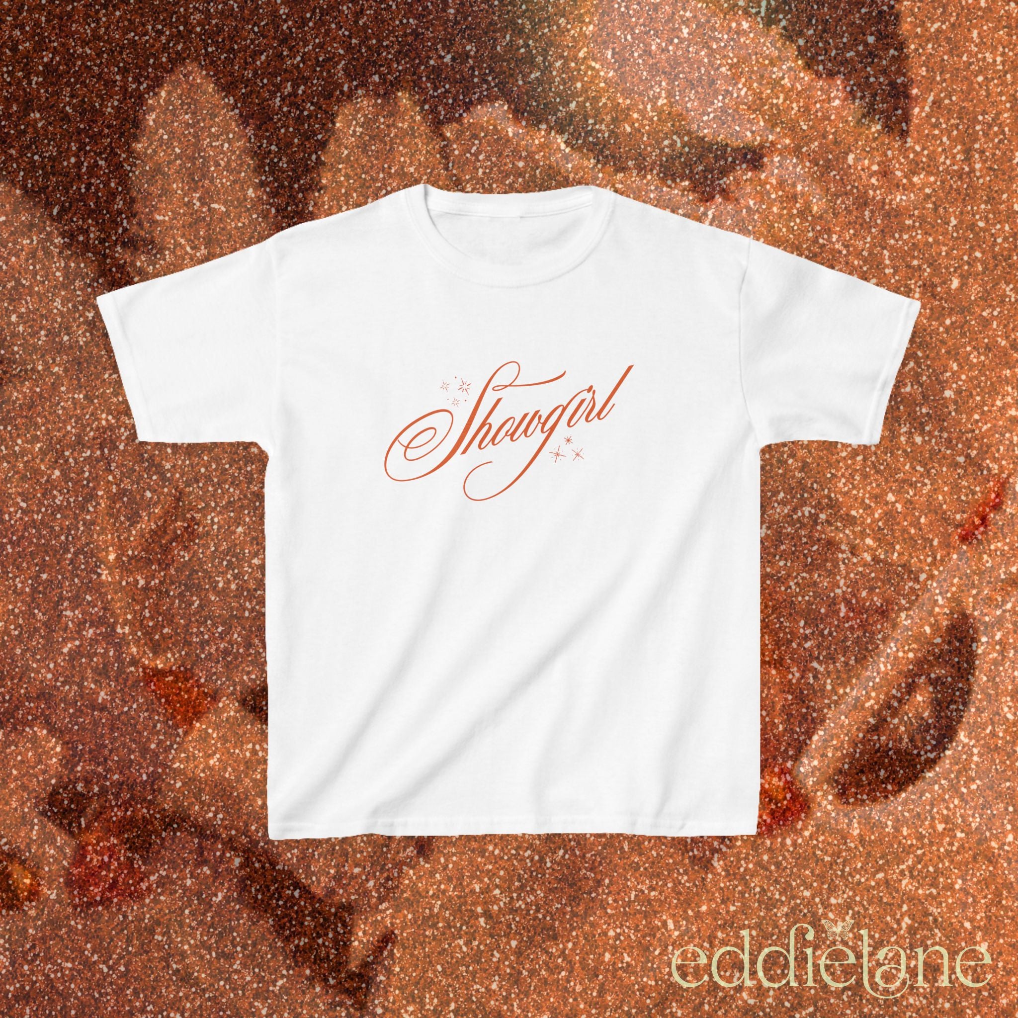 a white baby tee with cursive text that says 'Showgirl' 

white baby tee
