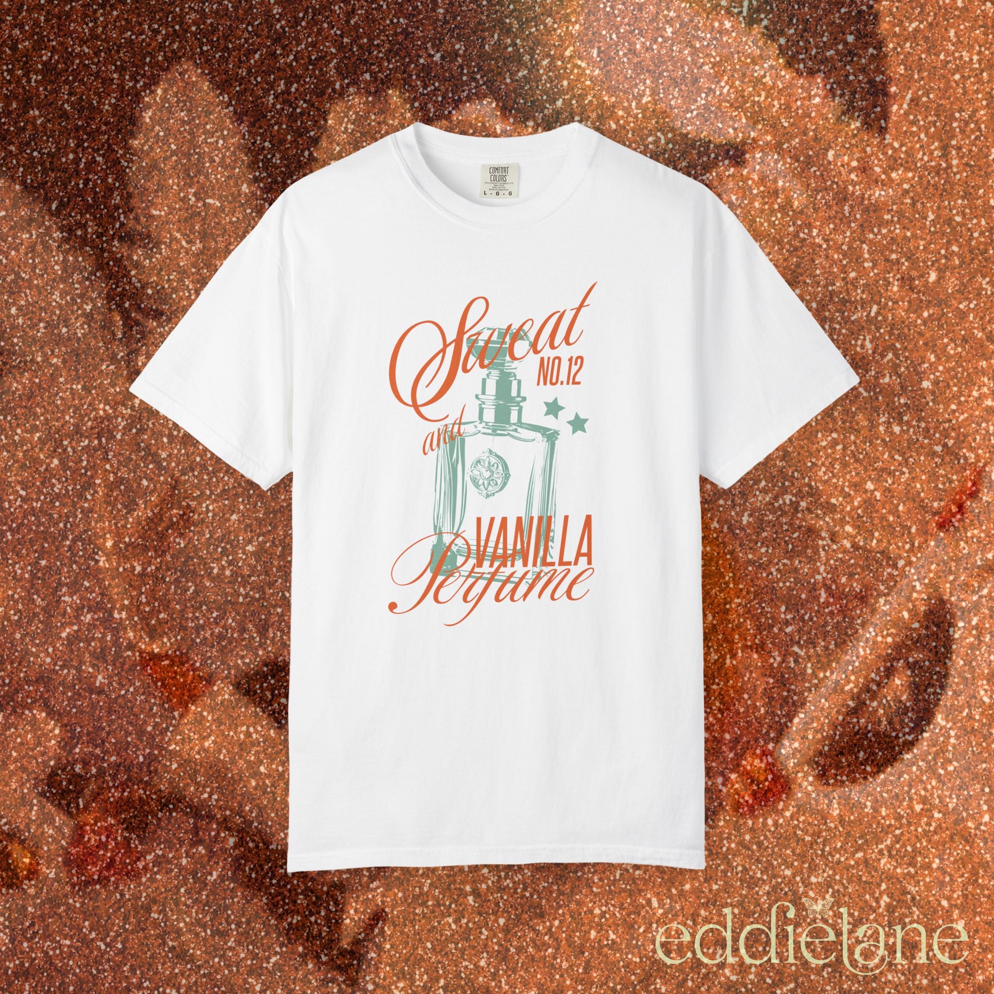 woman wearing a white comfort colors graphic tee with an illustration of a perfume bottle and the words "sweat and vanilla perfume" 