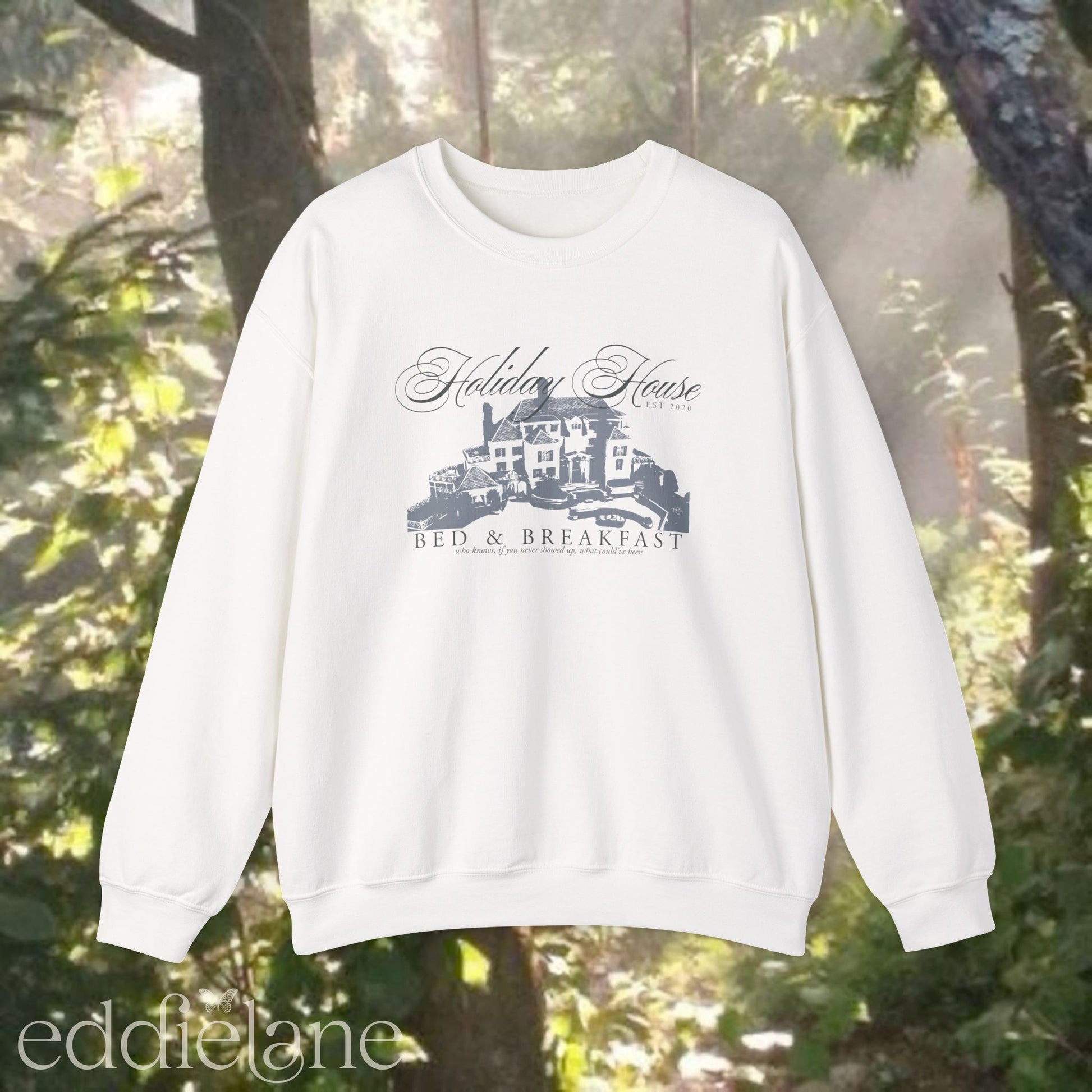 white crewneck sweatshirt that says "Holiday House Bed and Breakfast" with a silhouette of the holiday house from taylor swift's the last great american dynasty from folklore.
white swiftie sweatshirt holiday house