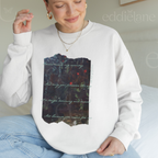 Woman wearing a white sweatshirt with a picutre of a painting and the words "Locked inside my memory and only you possess the key no longer drowning and deceived all because you came for me"