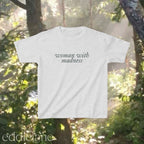 Light gray baby tee with words "woman with madness" 